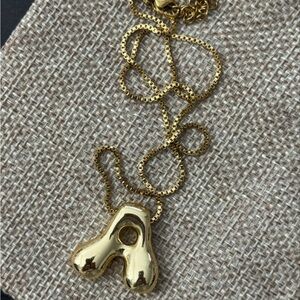 That famous gold balloon letter necklace. New